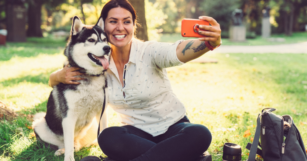 Woman taking selfie with her dog
